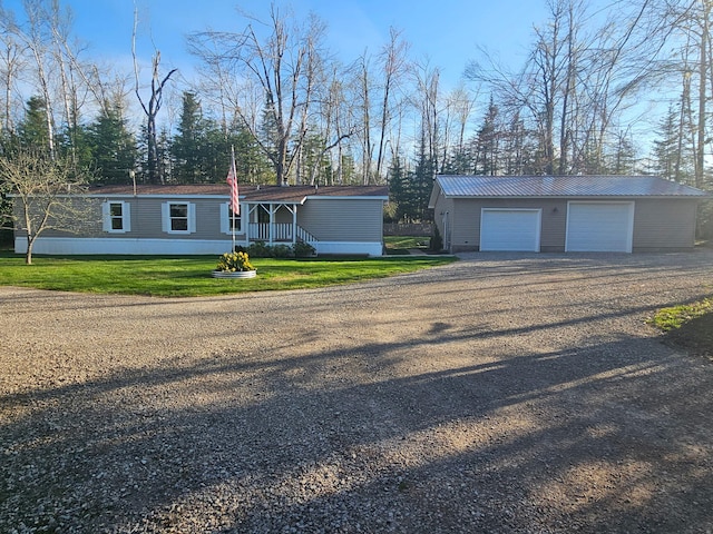 10340 US-23, Cheboygan, MI 49721 - manufactured / mobile home with an outbuilding, dirt driveway, a garage, metal roof, and a front yard