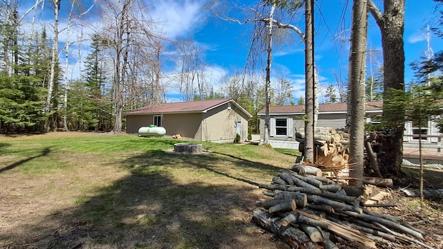 10340 US-23, Cheboygan, MI 49721 - back of house with a lawn and a fire pit
