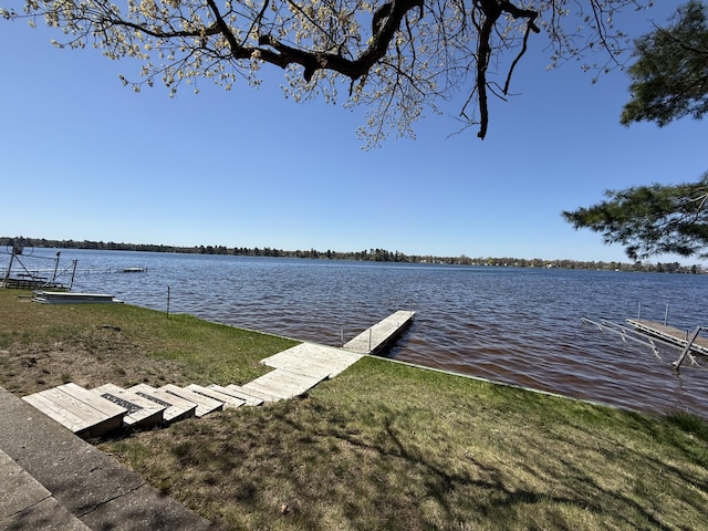 6299 Woodland Dr, Oscoda, MI 48750 - dock area with a water view and a lawn