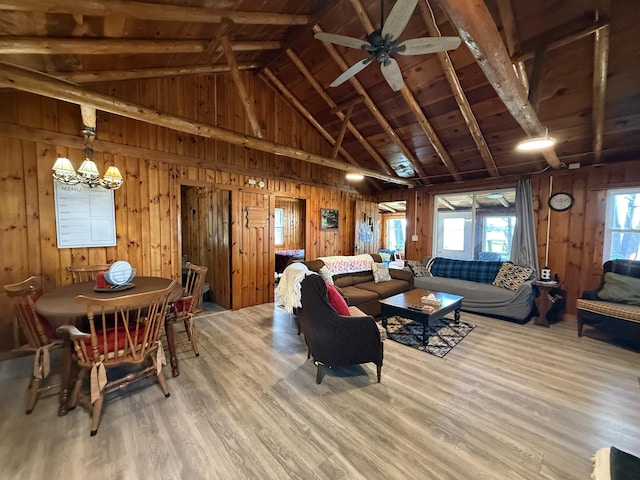 6299 Woodland Dr, Oscoda, MI 48750 - living room with wood finished floors, a chandelier, wooden walls, wood ceiling, and ceiling fan