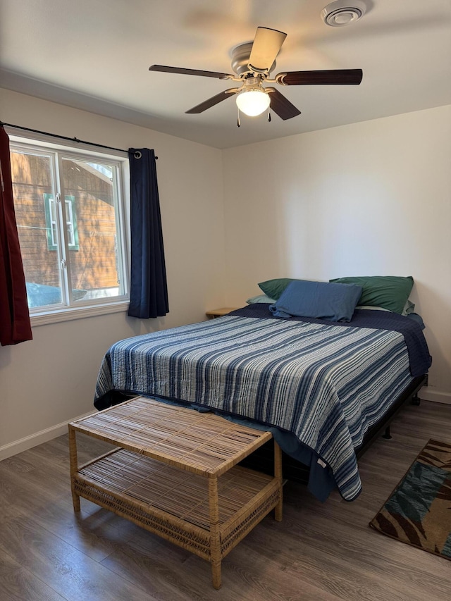 6299 Woodland Dr, Oscoda, MI 48750 - bedroom featuring wood finished floors, baseboards, and a ceiling fan
