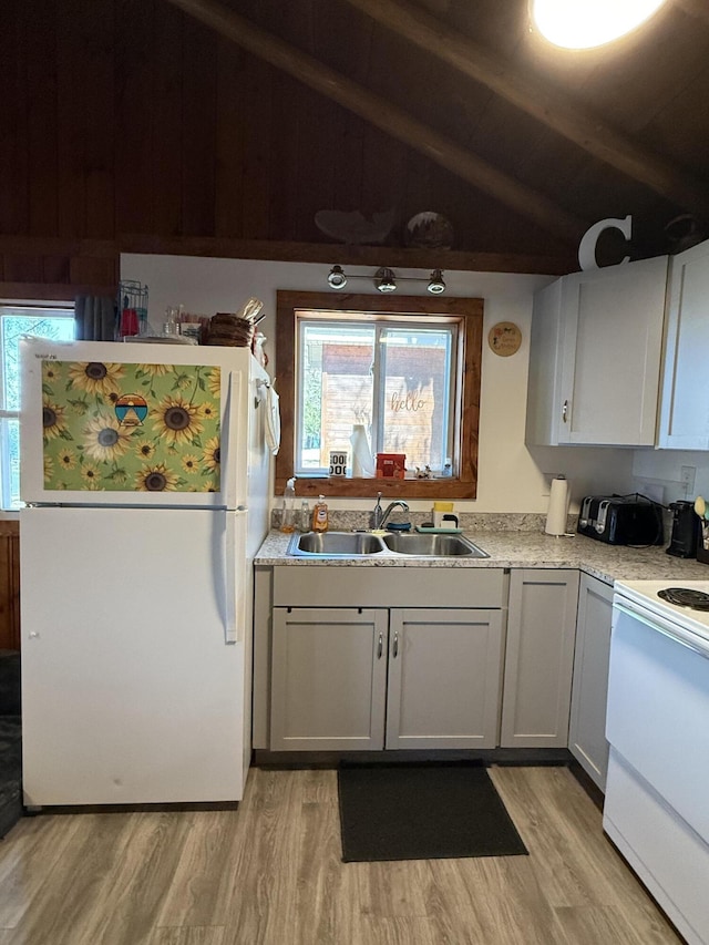 6299 Woodland Dr, Oscoda, MI 48750 - kitchen with freestanding refrigerator, a sink, range, and light wood finished floors