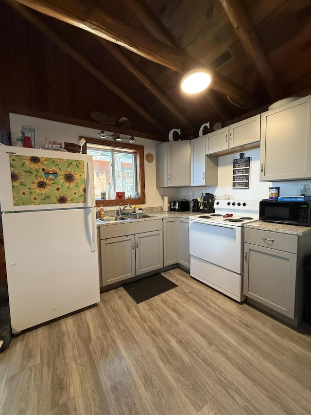 6299 Woodland Dr, Oscoda, MI 48750 - kitchen featuring white appliances, a sink, light wood-style flooring, wood ceiling, and light countertops
