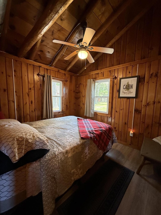 6299 Woodland Dr, Oscoda, MI 48750 - bedroom with wood finished floors, multiple windows, wooden ceiling, wooden walls, and ceiling fan