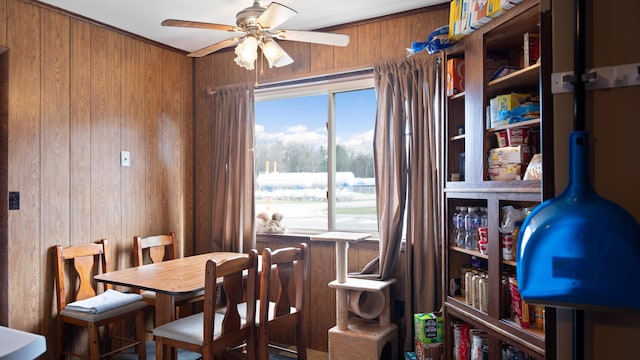 3182 W Houghton Lake Dr, Houghton Lake, MI 48629 - dining space featuring wooden walls and a ceiling fan