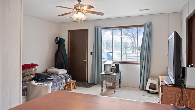 3182 W Houghton Lake Dr, Houghton Lake, MI 48629 - carpeted bedroom with a ceiling fan and a decorative wall