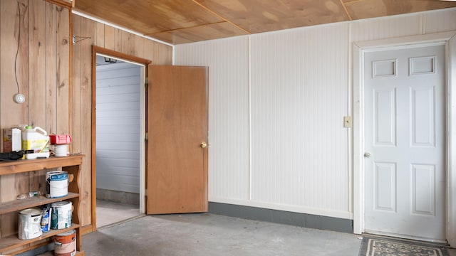 3182 W Houghton Lake Dr, Houghton Lake, MI 48629 - empty room with concrete flooring and wooden walls