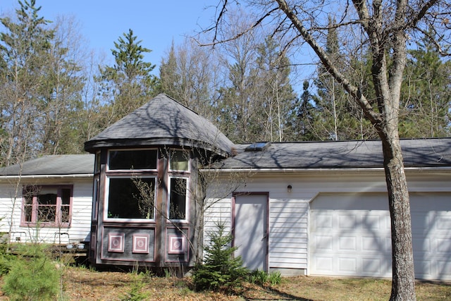 2032 W Oak Rd, Luzerne, MI 48636 - view of front of home featuring a garage and a shingled roof