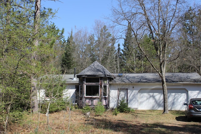 2032 W Oak Rd, Luzerne, MI 48636 - view of front of property featuring a garage and a shingled roof
