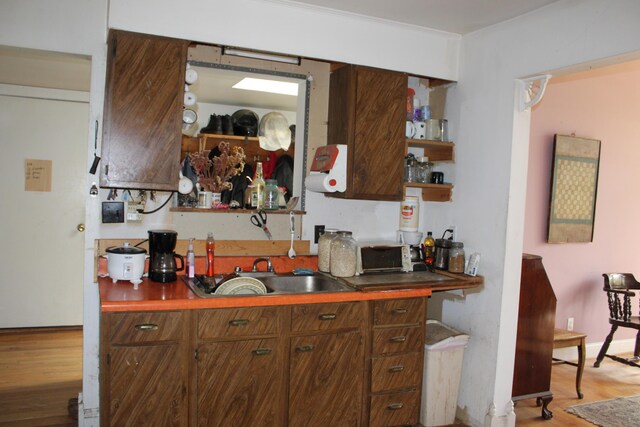 2032 W Oak Rd, Luzerne, MI 48636 - kitchen with wood finished floors, a sink, and open shelves