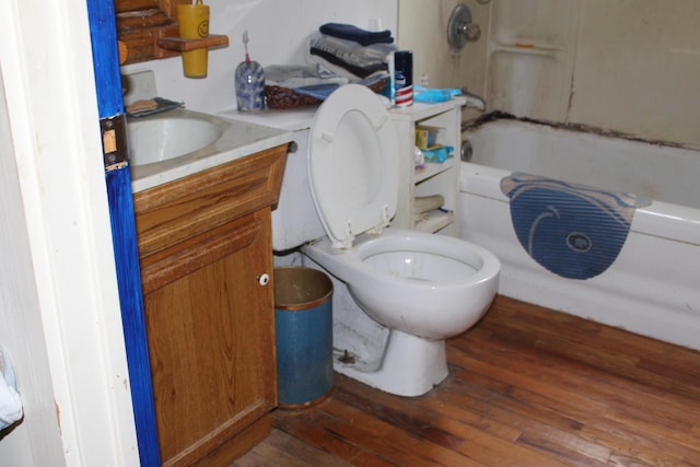 2032 W Oak Rd, Luzerne, MI 48636 - bathroom with wood-type flooring, toilet, vanity, and bathtub / shower combination