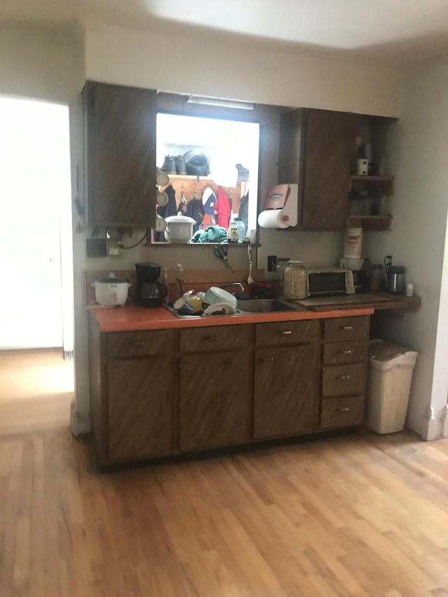 2032 W Oak Rd, Luzerne, MI 48636 - bar area featuring light wood-style floors and a sink
