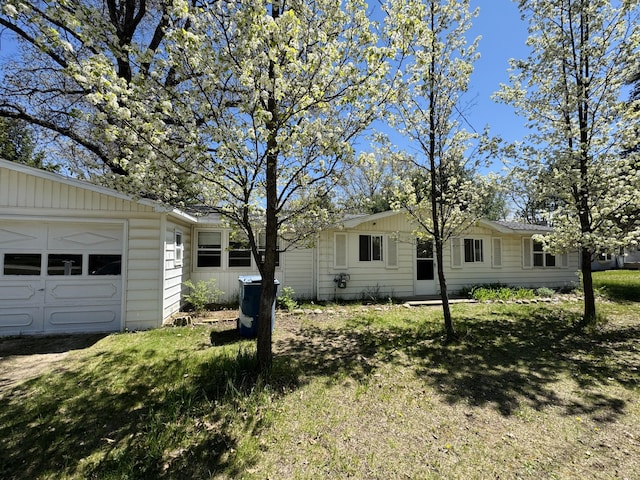 1654 Opland Rd, Gladwin, MI 48624 - view of green lawn with a garage