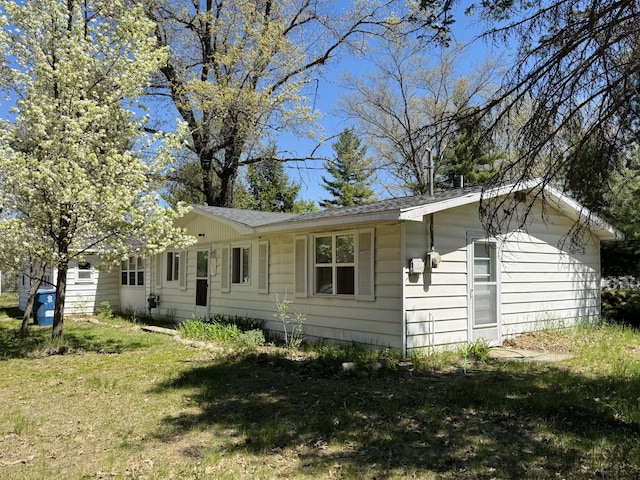 1654 Opland Rd, Gladwin, MI 48624 - view of side of property featuring a lawn