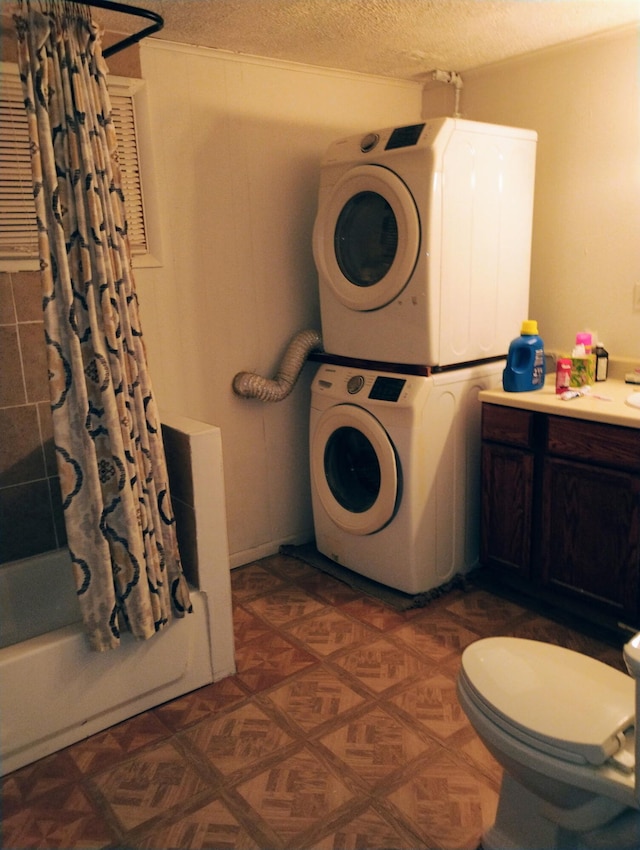 1654 Opland Rd, Gladwin, MI 48624 - laundry area with estacked washer and dryer and a textured ceiling