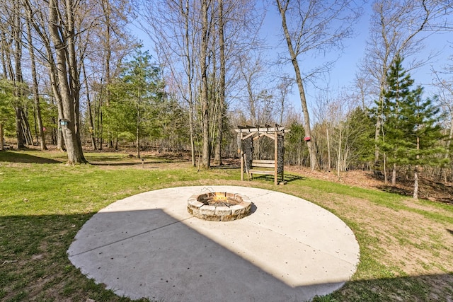 343 Crystal Ln, Roscommon, MI 48653 - view of grassy yard featuring an outdoor fire pit, a patio, and a pergola