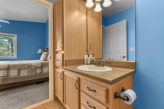 343 Crystal Ln, Roscommon, MI 48653 - ensuite bathroom featuring vanity, tile patterned flooring, and a chandelier