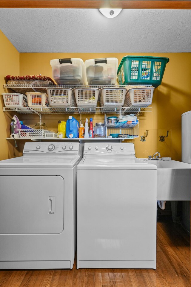 343 Crystal Ln, Roscommon, MI 48653 - washroom with separate washer and dryer, wood finished floors, and a textured ceiling