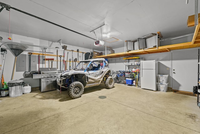 343 Crystal Ln, Roscommon, MI 48653 - garage with freestanding refrigerator, electric panel, and a garage door opener