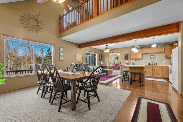 343 Crystal Ln, Roscommon, MI 48653 - dining space featuring ceiling fan, light wood-style floors, and beamed ceiling
