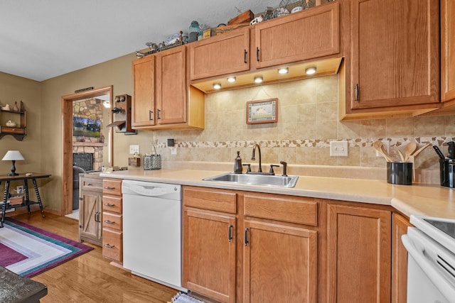 343 Crystal Ln, Roscommon, MI 48653 - kitchen featuring white dishwasher, decorative backsplash, light countertops, light wood finished floors, and stove