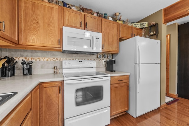 343 Crystal Ln, Roscommon, MI 48653 - kitchen featuring white appliances, backsplash, light countertops, and light wood-style floors