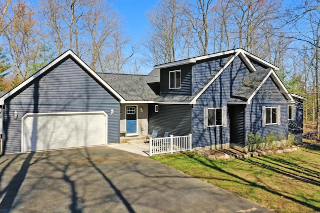 343 Crystal Ln, Roscommon, MI 48653 - view of front of property featuring a garage, asphalt driveway, and roof with shingles