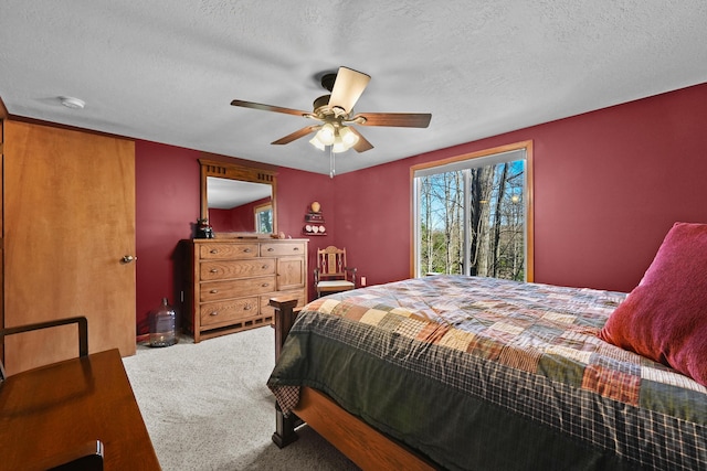 343 Crystal Ln, Roscommon, MI 48653 - bedroom with carpet floors, a textured ceiling, a ceiling fan, and access to exterior
