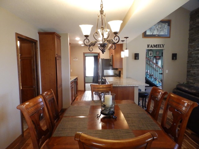 7928 Blueberry Ln, Johannesburg, MI 49751 - dining space featuring stairway, wood finished floors, and a chandelier