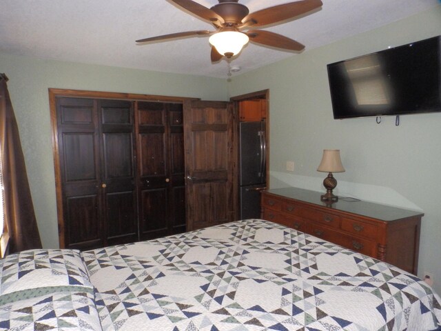 7928 Blueberry Ln, Johannesburg, MI 49751 - bedroom with freestanding refrigerator, a closet, and ceiling fan