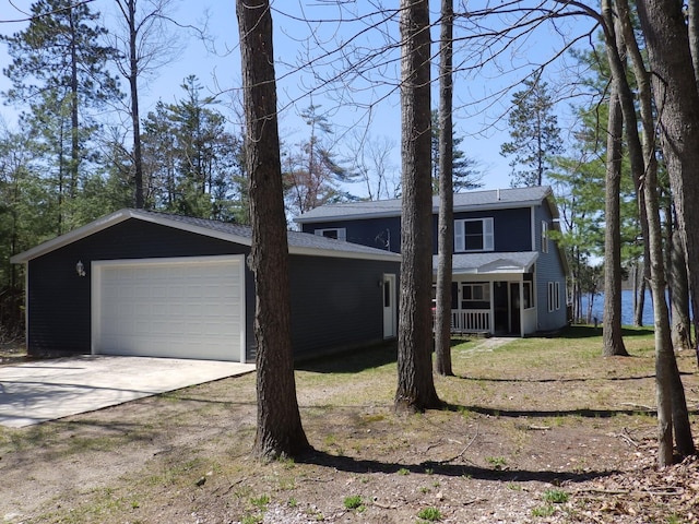 7928 Blueberry Ln, Johannesburg, MI 49751 - view of front of home featuring concrete driveway, a front lawn, and roof with shingles