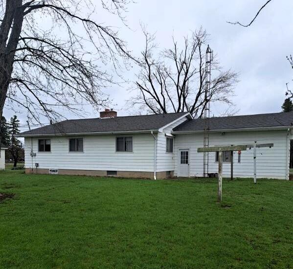 2056 N M-65, Lachine, MI 49753 - rear view of property featuring a lawn and a chimney