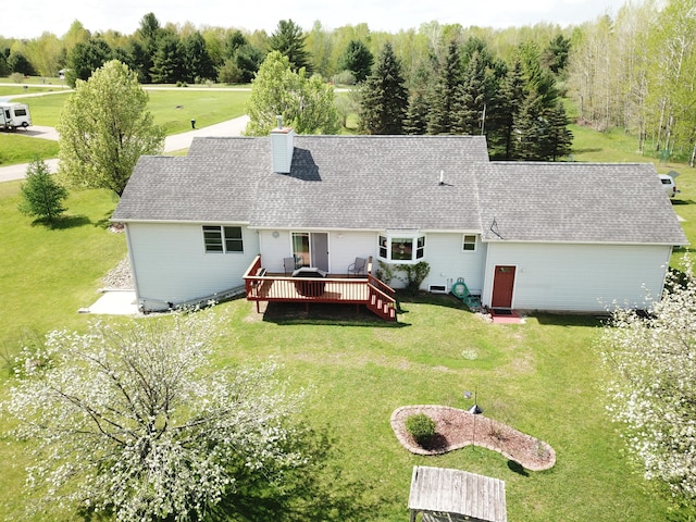 4930 Warrington Way, Gladwin, MI 48624 - rear view of property featuring a deck, a chimney, roof with shingles, and a lawn