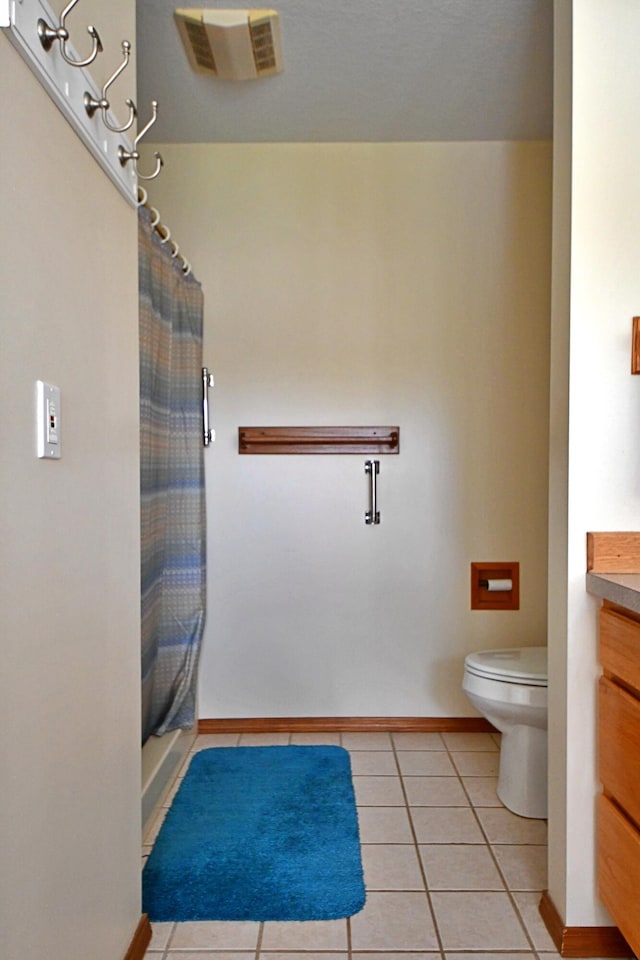 4930 Warrington Way, Gladwin, MI 48624 - full bathroom with vanity, toilet, tile patterned floors, and baseboards
