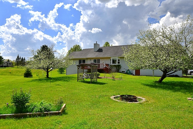 4930 Warrington Way, Gladwin, MI 48624 - rear view of house with a deck, a yard, a fire pit, and stairs