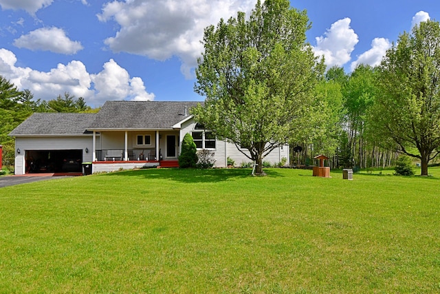 4930 Warrington Way, Gladwin, MI 48624 - view of front of house with a garage, a front lawn, driveway, and a porch