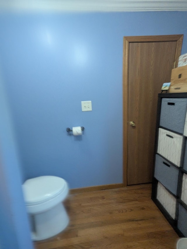 9367 Clewley Rd, Lachine, MI 49753 - bathroom with toilet, wood finished floors, and baseboards