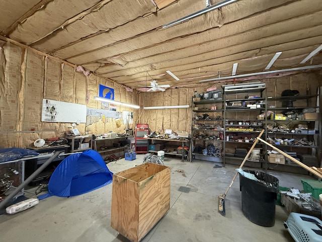 garage with a workshop area and ceiling fan