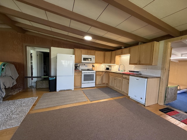 kitchen with white appliances, a sink, and light brown cabinetry