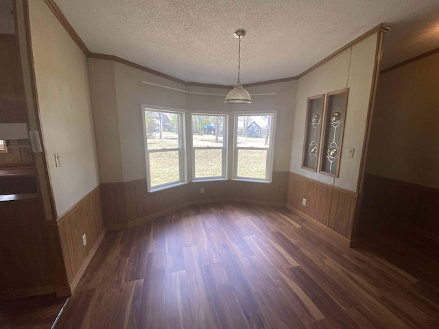 1364 Lakeview Dr, Mio, MI 48647 - unfurnished dining area with dark wood finished floors, wainscoting, crown molding, and a textured ceiling