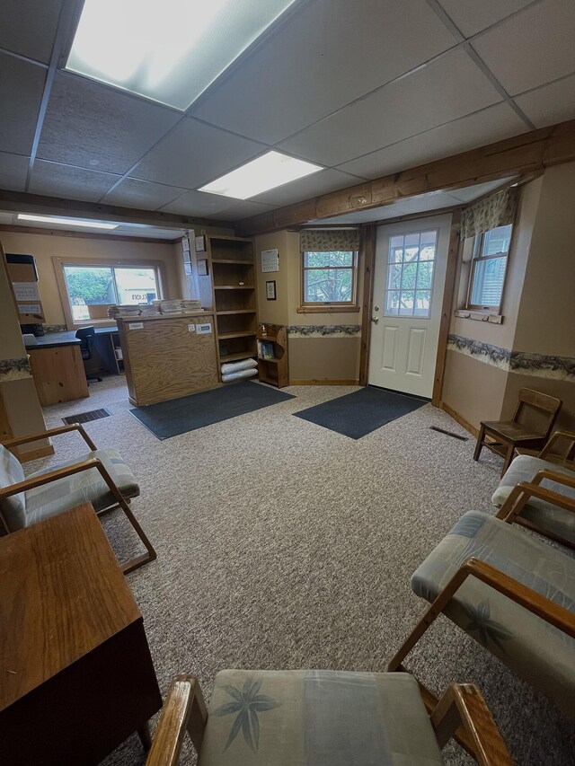 20417 State St, Onaway, MI 49765 - carpeted living room featuring a drop ceiling and plenty of natural light