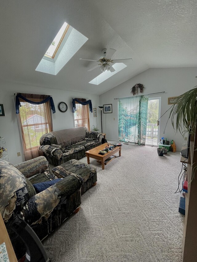 20417 State St, Onaway, MI 49765 - living area with a skylight, carpet, vaulted ceiling, plenty of natural light, and ceiling fan