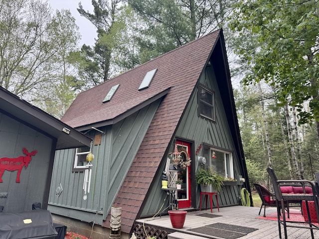 2733 Timberlane Trl, Grayling, MI 49738 - view of home's exterior with a shingled roof and a deck
