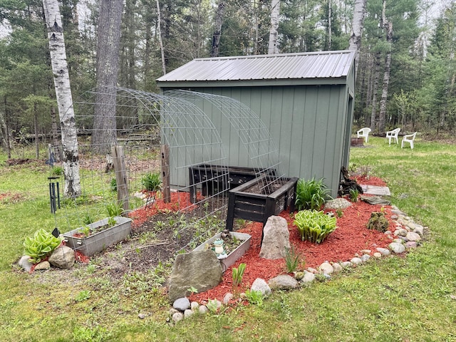 2733 Timberlane Trl, Grayling, MI 49738 - view of shed featuring a vegetable garden and a forest view