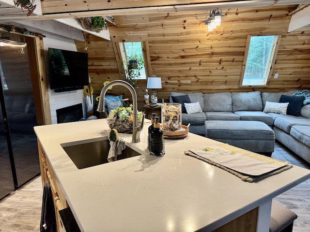 2733 Timberlane Trl, Grayling, MI 49738 - living area featuring wooden walls, healthy amount of natural light, light wood-type flooring, and a large fireplace
