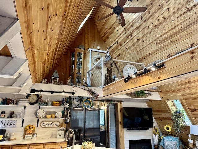 2733 Timberlane Trl, Grayling, MI 49738 - living room featuring wood walls, ceiling fan, vaulted ceiling, and wood ceiling