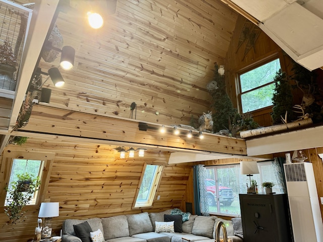 2733 Timberlane Trl, Grayling, MI 49738 - living room with wooden walls, a heating unit, and high vaulted ceiling