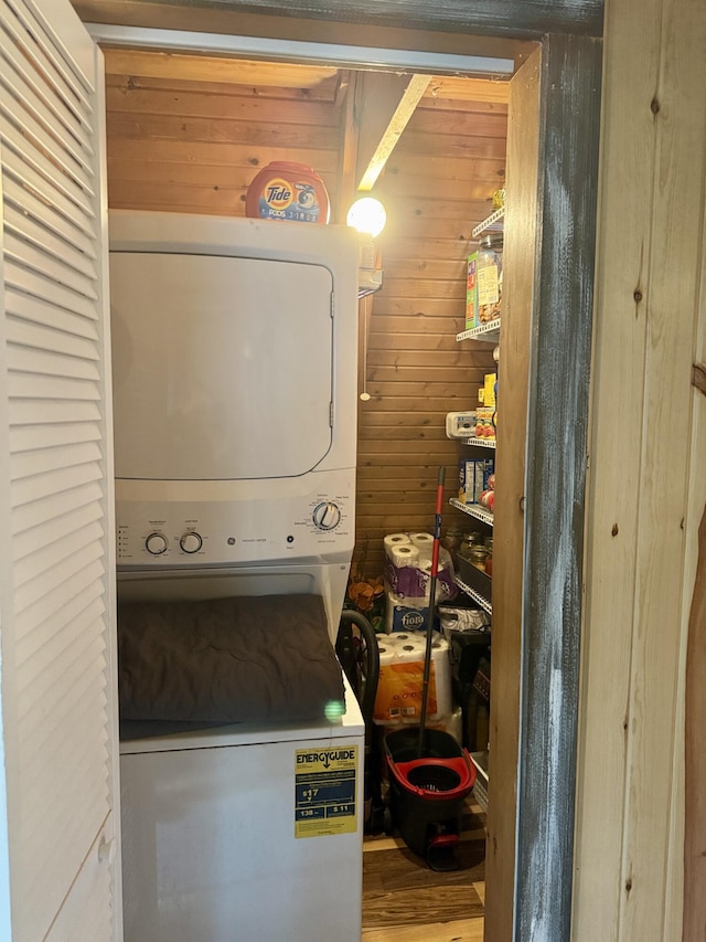 2733 Timberlane Trl, Grayling, MI 49738 - washroom with stacked washer / drying machine, wood walls, and wood finished floors