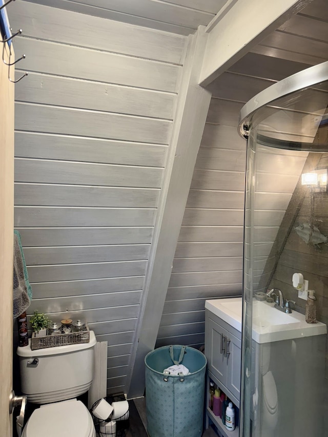 2733 Timberlane Trl, Grayling, MI 49738 - bathroom featuring wood walls, toilet, and vanity