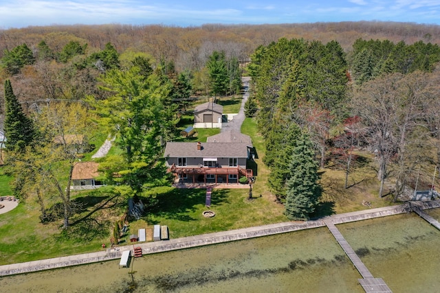 view of subject property with a heavily wooded area